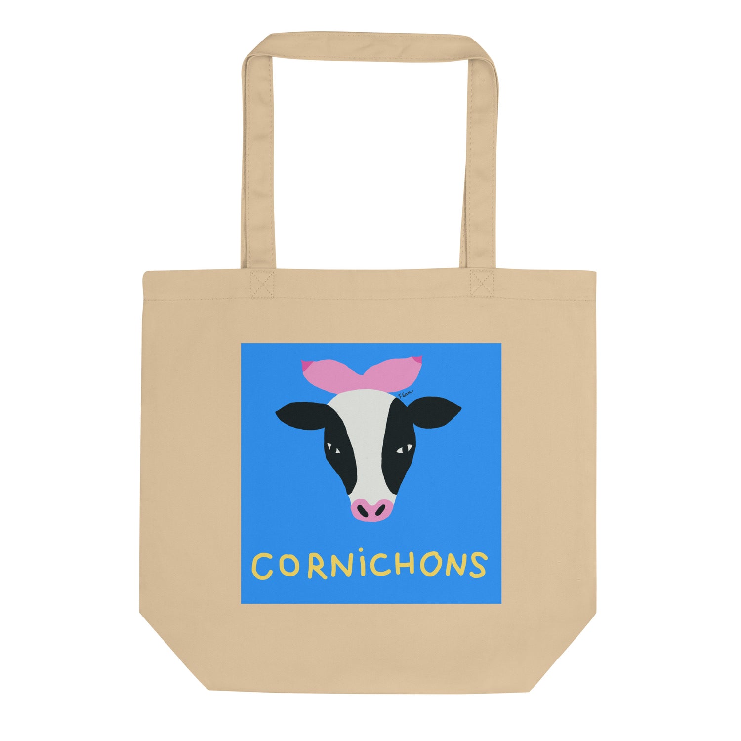 Tote bag beige en coton bio affichant un carré bleu avec une tête de vache dont les cornes sont des seins roses, titre Cornichons en jaune.